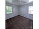Bedroom featuring neutral walls, two large windows, carpet and a ceiling fan at 309 Fannie Cir, Charlotte, NC 28205