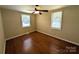 Bedroom with hardwood floors, neutral walls, ceiling fan and two windows at 309 Fannie Cir, Charlotte, NC 28205