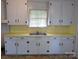 Classic kitchen with white cabinets and a contrasting yellow countertop at 309 Fannie Cir, Charlotte, NC 28205
