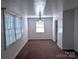 Bright living room with large windows, neutral paint, and a ceiling fan at 309 Fannie Cir, Charlotte, NC 28205