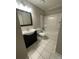 Bathroom features a dark vanity and a tub with shower at 3200 Heathstead Pl # E, Charlotte, NC 28210