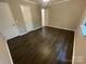 Bedroom featuring hardwood floors, neutral paint, and ample closet space at 3200 Heathstead Pl # E, Charlotte, NC 28210