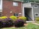 Brick and siding exterior showcasing the entryway and landscaping at 3200 Heathstead Pl # E, Charlotte, NC 28210