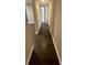 A hallway featuring hardwood floors and neutral paint at 3200 Heathstead Pl # E, Charlotte, NC 28210
