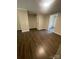 Spacious living room featuring hardwood floors and neutral paint at 3200 Heathstead Pl # E, Charlotte, NC 28210