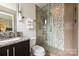 Modern bathroom features a glass shower, decorative tile, granite vanity, and stylish lighting at 333 W 7Th St, Charlotte, NC 28202