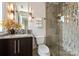 Modern bathroom features a glass shower, decorative tile, granite vanity, and stylish lighting at 333 W 7Th St, Charlotte, NC 28202