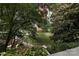Green space view with walking path and benches, surrounded by trees and building in the background at 333 W 7Th St, Charlotte, NC 28202