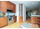 Modern kitchen featuring stainless steel appliances, granite countertops, and wood cabinets at 333 W 7Th St, Charlotte, NC 28202