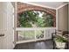 Charming porch with brick archway, seating, and view of greenery at 333 W 7Th St, Charlotte, NC 28202