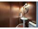 Elegant powder room with pedestal sink, wood floors, and decorative lighting at 333 W 7Th St, Charlotte, NC 28202