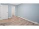 Clean bedroom with light blue walls, wood flooring, and a walk-in closet at 3433 Spinner Ct, Sherrills Ford, NC 28673