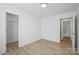 Bright bedroom featuring neutral walls, wood-look floors, and a convenient ensuite bathroom and closet at 3433 Spinner Ct, Sherrills Ford, NC 28673