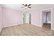 Inviting bedroom features pale pink walls, vinyl plank flooring, and convenient bathroom and closet access at 3433 Spinner Ct, Sherrills Ford, NC 28673