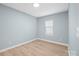 Bright, empty bedroom with light blue walls and wood flooring, showcasing a simple design at 3433 Spinner Ct, Sherrills Ford, NC 28673
