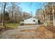 Great view of home featuring a side screened-in porch, a gravel driveway and well-maintained lawn for outdoor living at 3433 Spinner Ct, Sherrills Ford, NC 28673