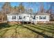 Charming single-story home featuring white siding, brick foundation, covered entry and a well-manicured front lawn at 3433 Spinner Ct, Sherrills Ford, NC 28673