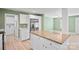 Bright, updated kitchen with white cabinets, a stainless steel refrigerator and a functional island with a wood countertop at 3433 Spinner Ct, Sherrills Ford, NC 28673