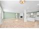 Open living room with a fireplace, light wood floors and views into the kitchen at 3433 Spinner Ct, Sherrills Ford, NC 28673