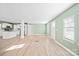 Bright living room with light wood floors and a modern kitchen area with white cabinets at 3433 Spinner Ct, Sherrills Ford, NC 28673