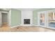 Cozy living space showcasing a white brick fireplace and French doors leading to the deck at 3433 Spinner Ct, Sherrills Ford, NC 28673