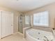 Corner view of a bathroom showcasing a tiled corner tub and glass enclosed shower stall at 3533 Weddington Ridge Ln, Matthews, NC 28105