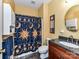Bright bathroom features a dark vanity with granite counters and unique sun and moon shower curtain at 3533 Weddington Ridge Ln, Matthews, NC 28105