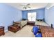 Blue bedroom featuring two twin beds, a ceiling fan, and a window for lots of natural light at 3533 Weddington Ridge Ln, Matthews, NC 28105