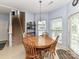 Sunny breakfast nook featuring a round table, four chairs, and sliding glass door leading to the backyard at 3533 Weddington Ridge Ln, Matthews, NC 28105