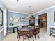 Light-filled dining room with blue walls, a chandelier, and a view into the adjacent kitchen at 3533 Weddington Ridge Ln, Matthews, NC 28105