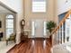 Inviting foyer featuring hardwood flooring, a staircase, and abundant natural light at 3533 Weddington Ridge Ln, Matthews, NC 28105