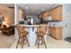 The kitchen includes a breakfast bar with seating, light wood cabinets, and view to the dining room at 3533 Weddington Ridge Ln, Matthews, NC 28105