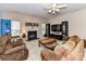 Inviting living room with a fireplace, plush armchairs, and a large television for entertaining at 3533 Weddington Ridge Ln, Matthews, NC 28105