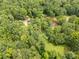 Picturesque aerial view of a home nestled in a dense forest, featuring a serene pond and lush greenery at 3547 Willowood Pond Dr, Rock Hill, SC 29730