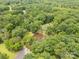 Expansive aerial view of a wooded property with a large pond, perfect for a serene and private retreat at 3547 Willowood Pond Dr, Rock Hill, SC 29730