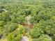 Breathtaking aerial view showcasing a lush, wooded property with a pond, offering a serene and private lifestyle at 3547 Willowood Pond Dr, Rock Hill, SC 29730