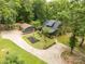 Charming home with manicured yard, garden, detached garage, and lush trees surrounding the property at 3547 Willowood Pond Dr, Rock Hill, SC 29730