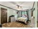 Bedroom with a ceiling fan, window, door, and a dresser with a television at 3547 Willowood Pond Dr, Rock Hill, SC 29730