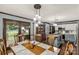 Bright dining area with French doors, wooden table set with pendant lights, and backyard access at 3547 Willowood Pond Dr, Rock Hill, SC 29730