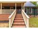 Inviting front porch with brick steps, white railings, and a dark wood front door at 3547 Willowood Pond Dr, Rock Hill, SC 29730