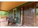 Charming front porch featuring rocking chairs and wooden accents for relaxing and enjoying the outdoors at 3547 Willowood Pond Dr, Rock Hill, SC 29730
