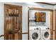 Functional laundry room with a side-by-side washer and dryer, storage cabinets, and a utility sink at 3547 Willowood Pond Dr, Rock Hill, SC 29730