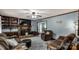 Inviting living room with a stone fireplace, wood mantel, and comfortable seating arrangements with natural light at 3547 Willowood Pond Dr, Rock Hill, SC 29730