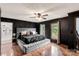Tastefully decorated main bedroom with dark walls, a tufted headboard, and a window view at 3547 Willowood Pond Dr, Rock Hill, SC 29730