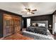 Stylishly decorated main bedroom with modern accents, a tufted headboard, and wood flooring at 3547 Willowood Pond Dr, Rock Hill, SC 29730