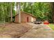 Functional outbuilding with a covered area and garage door, offering storage and workspace on a wooded lot at 3547 Willowood Pond Dr, Rock Hill, SC 29730