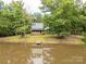 Charming home with a private pond and dock, surrounded by mature trees, reflecting a tranquil retreat at 3547 Willowood Pond Dr, Rock Hill, SC 29730