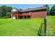 A spacious backyard featuring multi-level porch with brick and well-manicured lawn at 4010 Carlton Dr, Claremont, NC 28610