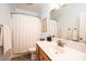 Well-lit bathroom with a vanity, toilet, and shower with a curtain at 4010 Carlton Dr, Claremont, NC 28610