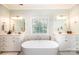 Luxurious bathroom featuring double vanities, marble accents, and a large soaking tub at 4010 Carlton Dr, Claremont, NC 28610